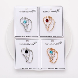 Detailed views of creative stethoscope brooches in gold and silver with colorful crystals