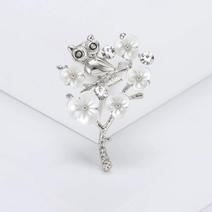 Elegant owl on plum blossom branch brooch with silver plating and white enamel crystals