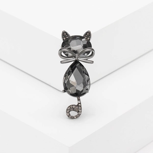 Elegant crystal cat brooch with bowknot and pavé rhinestones on minimalist white display