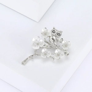 Detailed close-up of an owl perched on cherry blossoms with sparkling crystal accents