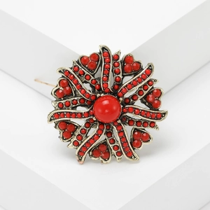 Vintage gold sunflower brooch with red beads in a retro bohemian floral style