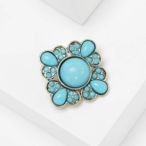 Bohemian vintage bronze brooch with large sky blue center stone on white display