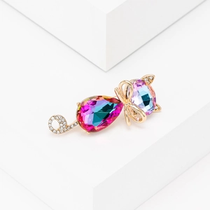 Exquisite gold cat brooch featuring faceted colorful crystal and rhinestone bow detailing