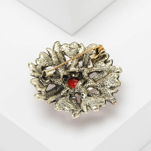 Macro detail of vintage alloy sunflower brooch back showing secure locking pin mechanism