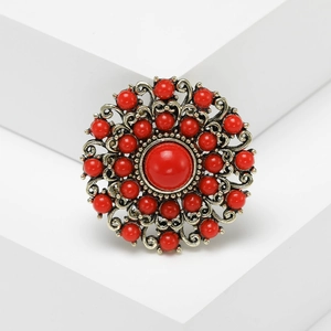Baroque style vintage red bead brooch with antique gold filigree metal base on stone