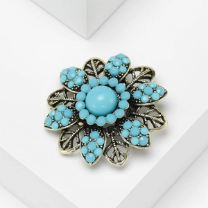 Vintage bohemian flower brooch with sky blue rhinestones and antique gold finish