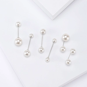 Set of 6 minimalist pearl brooches with silver metal pins on white geometric blocks