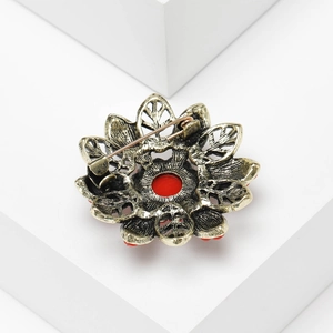 Close-up of the vintage flower brooch back showing bronze metal and long pin clasp