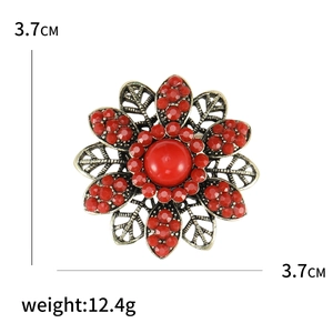 Vintage bohemian flower brooch in bronze finish with red rhinestones and floral petals