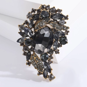 Vintage oversized brooch featuring a large oval smoky gemstone and grey crystals
