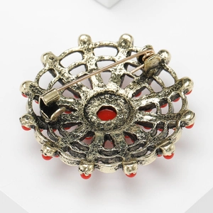 Detailed back view of vintage gold flower brooch showing pin mechanism and fine metalwork