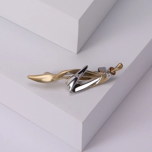 Minimalist two-tone alloy brooch with abstract curved leaf design and polished finish