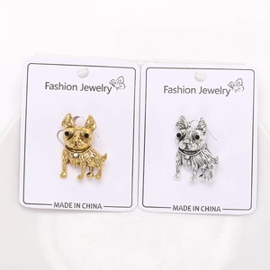 Macro detail of bulldog earrings in gold and silver finish with crystal studs on card
