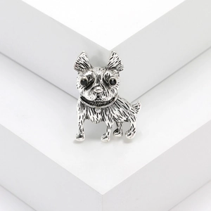 Vintage silver bulldog brooch with black gemstone eyes on minimalist stone pedestal