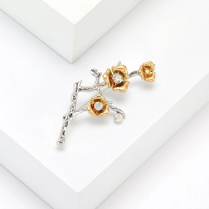 Elegant silver plum blossom branch brooch with golden flowers and rainbow rhinestones