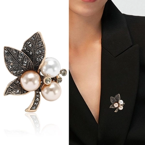 Vintage leaf brooch with grey rhinestones and pearls on a gold-tone metallic base