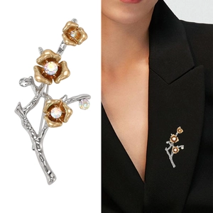 Elegant silver branch brooch with gold plum blossoms and crystal rhinestones on suit lapel