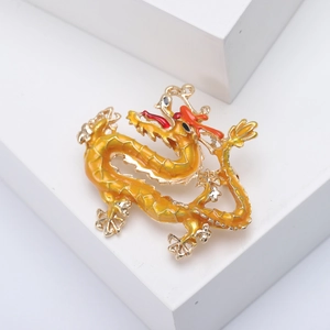 Exquisite enamel Chinese dragon brooch with golden and orange gradient details on white base