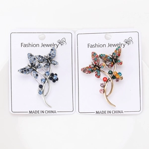 Detail of vintage butterfly brooches with colorful rhinestones on jewelry cards