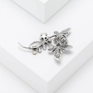 Detailed back view showing the sturdy silver pin fastening of the butterfly brooch