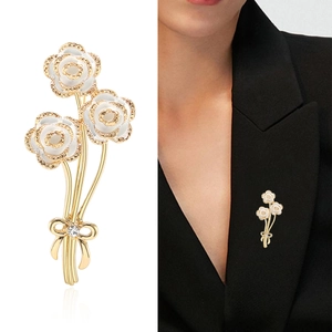 Elegant white enamel rose bouquet brooch with gold-plated petals and diamond bow
