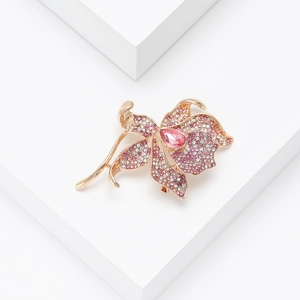 Luxury rose gold flower brooch featuring pink crystals and white rhinestones on geometric blocks