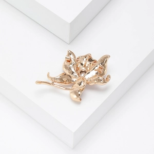 Back view of luxury gold crystal flower brooch showing the safety pin and metal texture