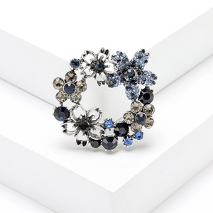 Elegant silver floral wreath brooch with sparkling blue rhinestones for blazer jackets