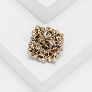 Detailed back view of vintage rhinestone brooch showing hollow metalwork and pin clasp