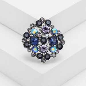 Vintage rhinestone brooch with blue and purple crystals in antique silver setting