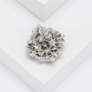 Detailed back view of vintage silver rhinestone brooch with secure safety pin closure