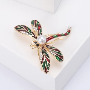 Détail de la broche libellule aux ailes émaillées, corps en perle et strass étincelants