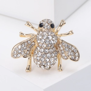 Exquisite gold-tone bee brooch with shimmering white rhinestones and black gem eyes