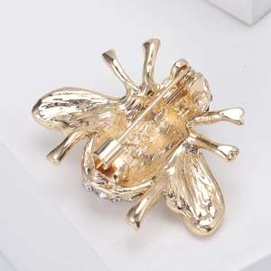 Detailed back view of gold bee brooch showing secure pin fastener and rhinestone edge