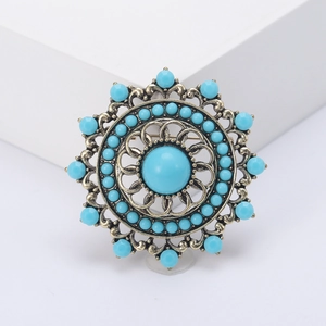 Vintage Turkish hollow brooch with turquoise stone and rhinestones on white background