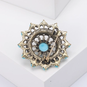 Macro shot of retro gold hollow brooch back featuring classic long pin closure
