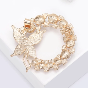 Detail view of the secure pin clasp and gold plating on the butterfly wreath brooch