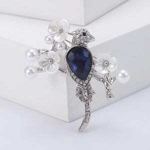 Vintage bird brooch with deep blue crystal, sparkling rhinestones and white pearls