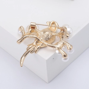 Detailed back view of vintage bird brooch showing secure pin fastener and gold finish
