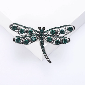 Elegant hollow dragonfly brooch featuring dark green rhinestones on vintage silver alloy