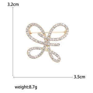 Broche nœud élégante avec strass brillants dorés, dimensions de 3,2 cm sur 3,5 cm
