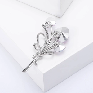 Close-up of heart crystal bouquet brooch with polished silver finish and micro-inlay zircon