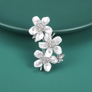 Elegant peach blossom brooch with white floral petals and sparkling zircon center stones