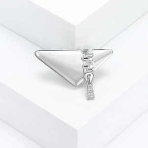 Minimalist silver triangle brooch with crystal zipper detail on white geometric display