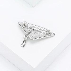 Macro shot showing silver triangle brooch texture and secure pin clasp mechanism