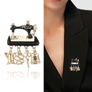 Vintage gold sewing machine brooch with enamel finish and hanging sewing tool charms