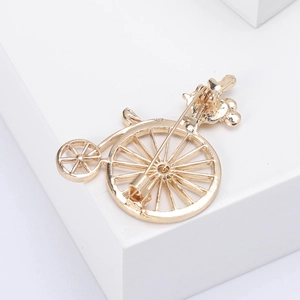 Detailed back view of vintage bicycle brooch showing secure pin clasp and gold alloy finish