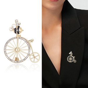 Vintage gold bicycle brooch with crystal rhinestones and a black enamel bee detail