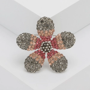 Exquisite five-petal flower brooch with gradient crystal rhinestones on white pedestal