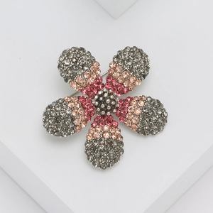 Elegant rhinestone flower brooch with pink and dark grey crystals on white background